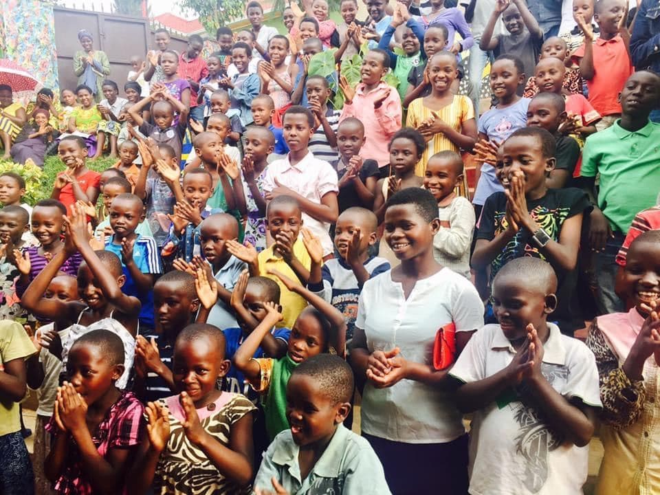 Children clapping and singing together at the Saturday program