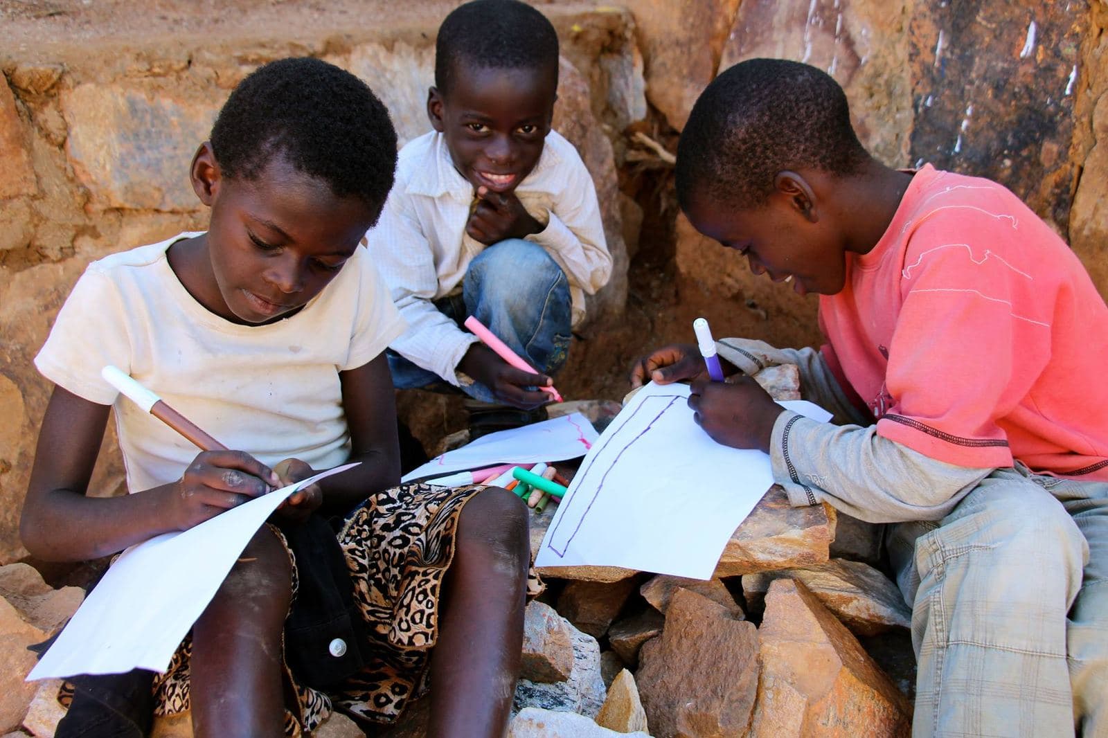 Children drawing together with colored markers