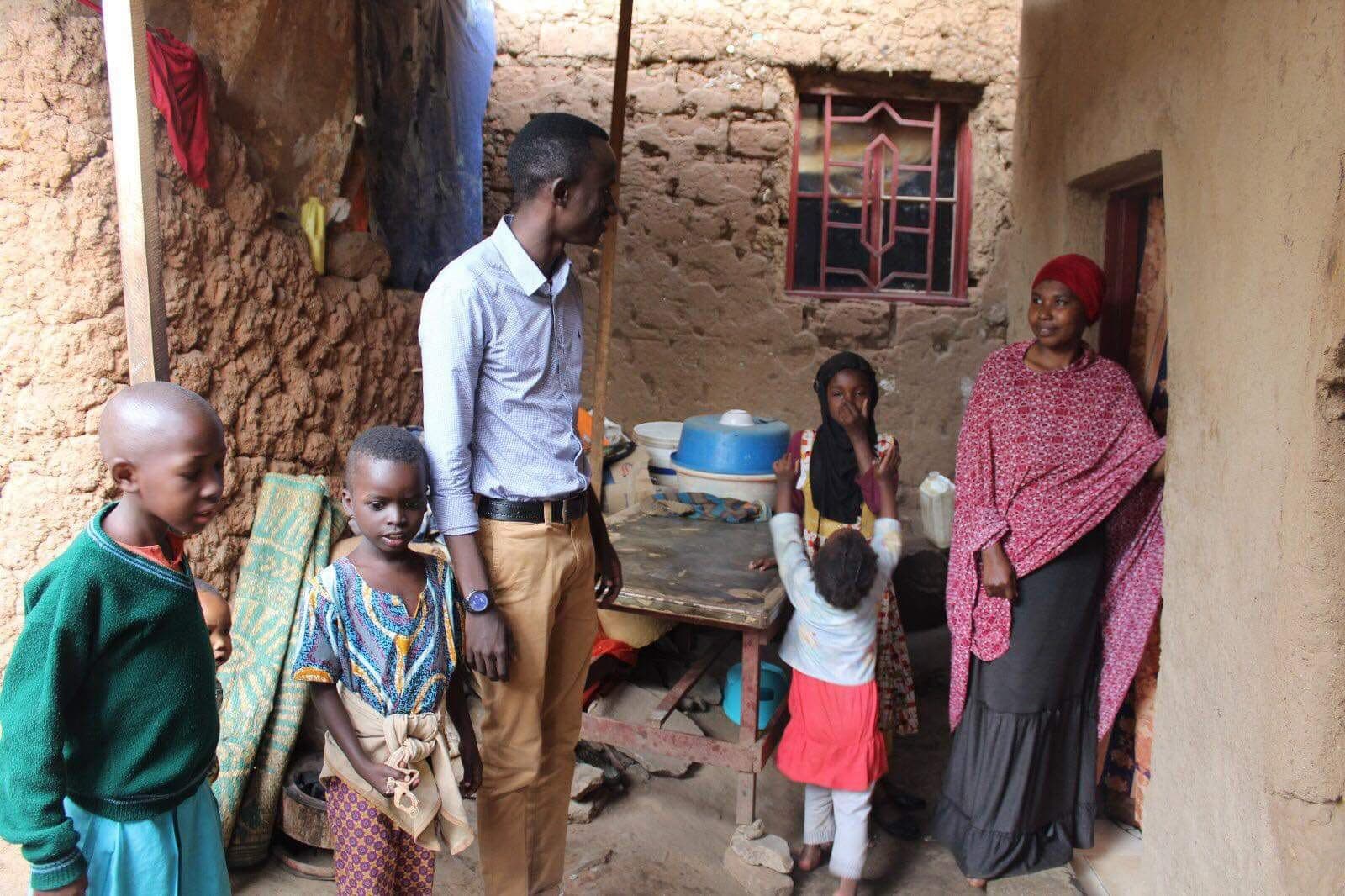 An Irembo team member visiting a family at their home