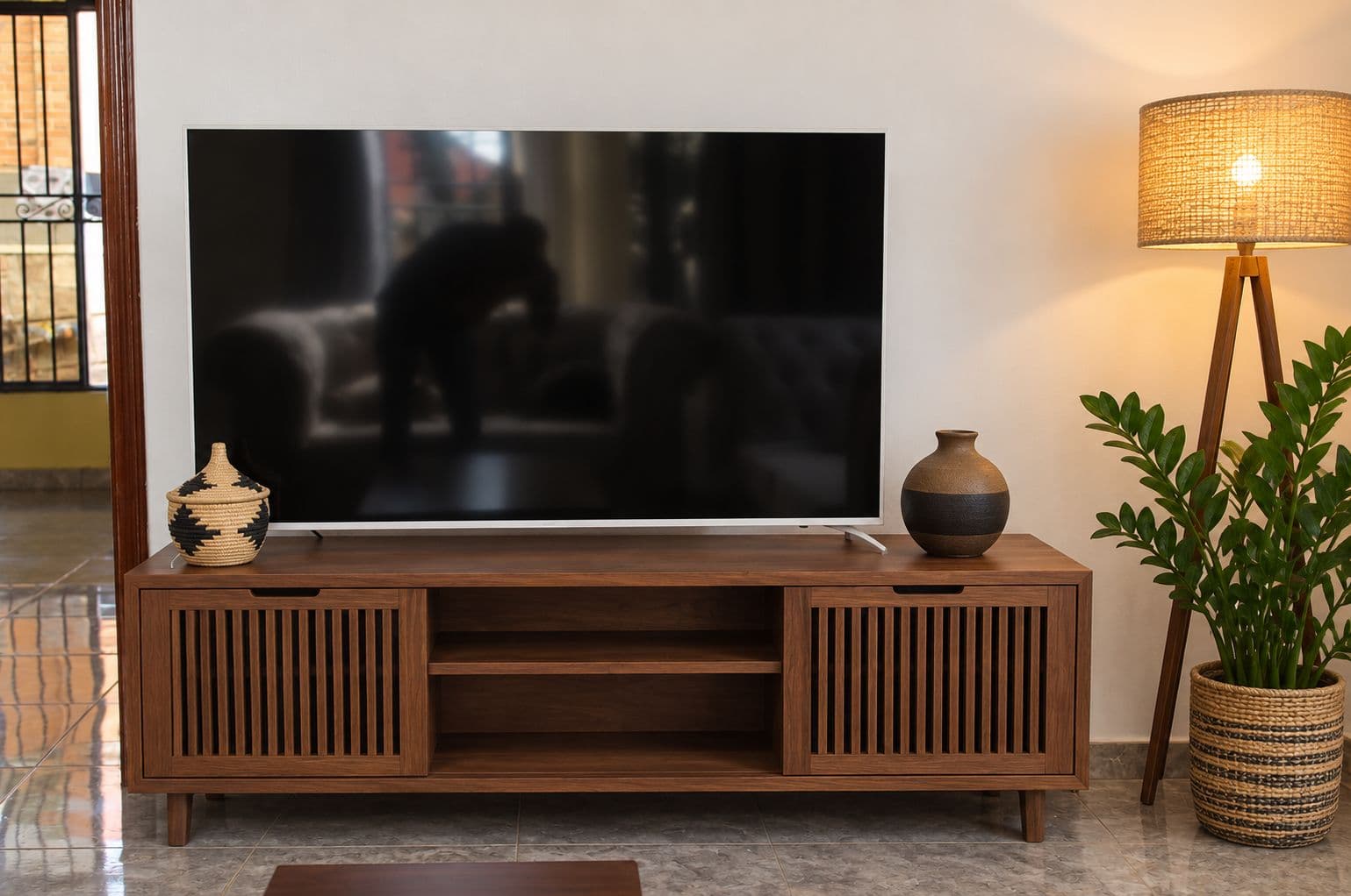 The TV lounge with a wooden cabinet and a floor lamp