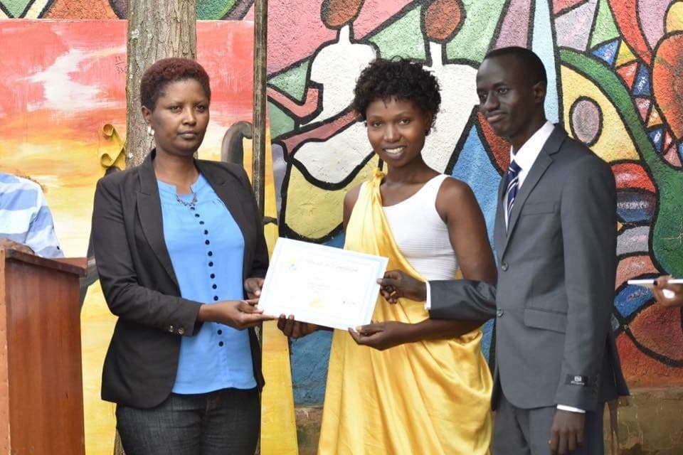 A Mama Rwanda graduate receiving her certificate