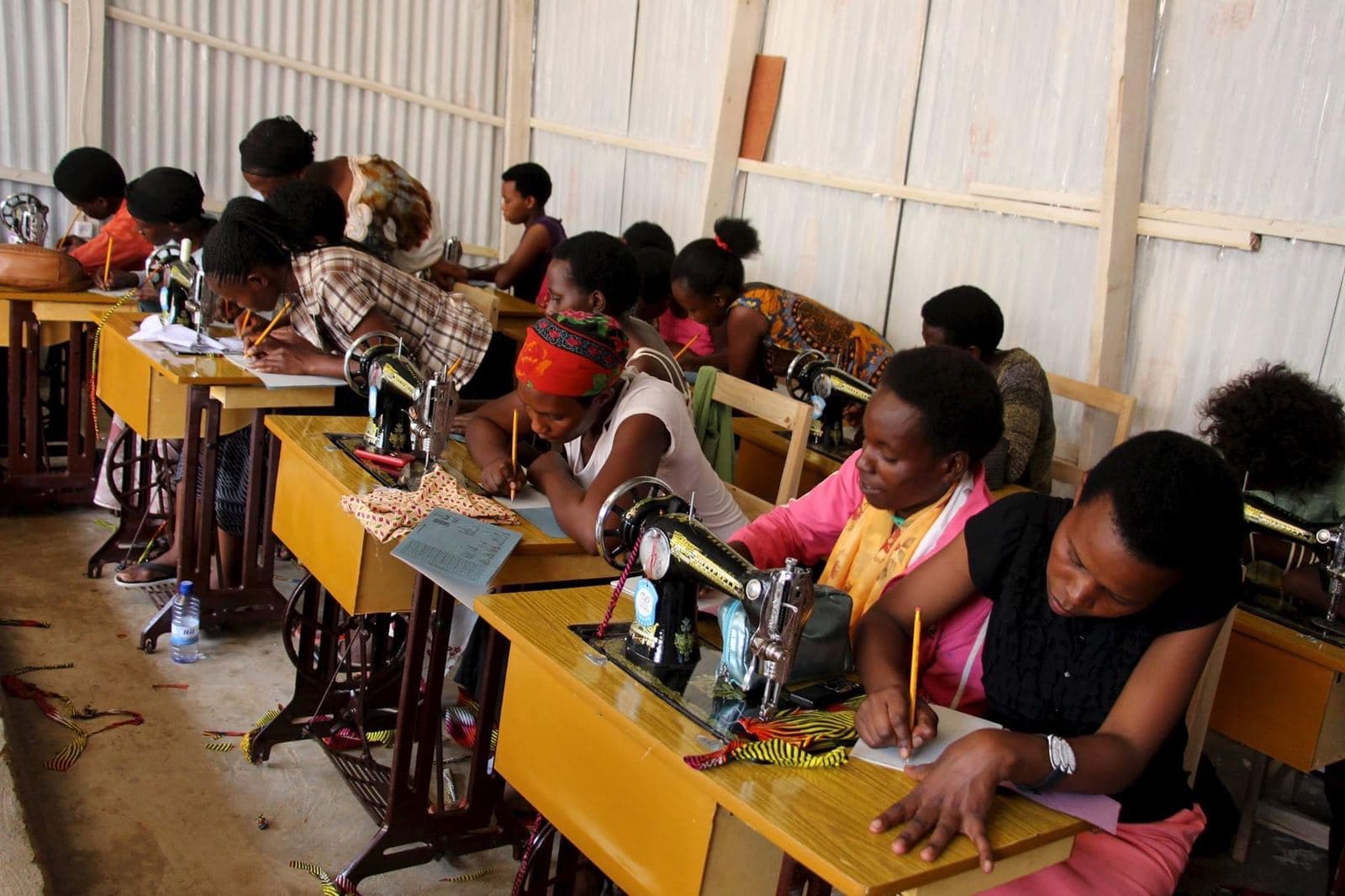 Women taking notes during a Mama Rwanda lesson
