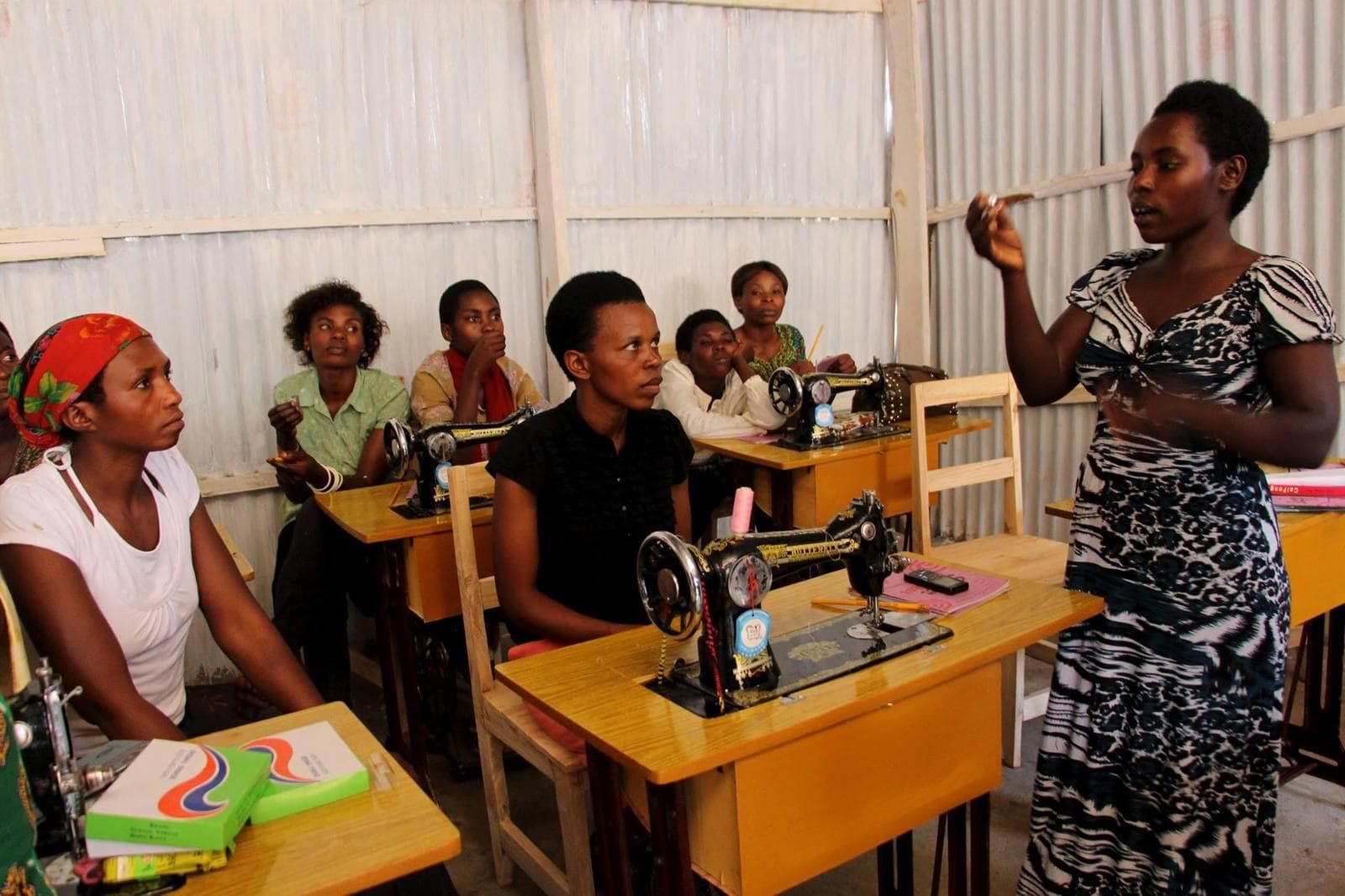 A Mama Rwanda teacher leading a class at the sewing machines