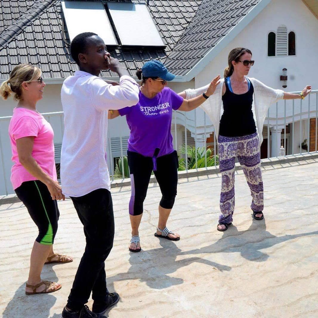 Visitors learning a Rwandan dance on the rooftop