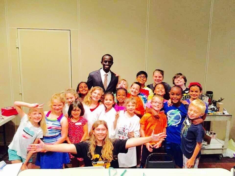 Bertrand Ishimwe with students during a school visit abroad