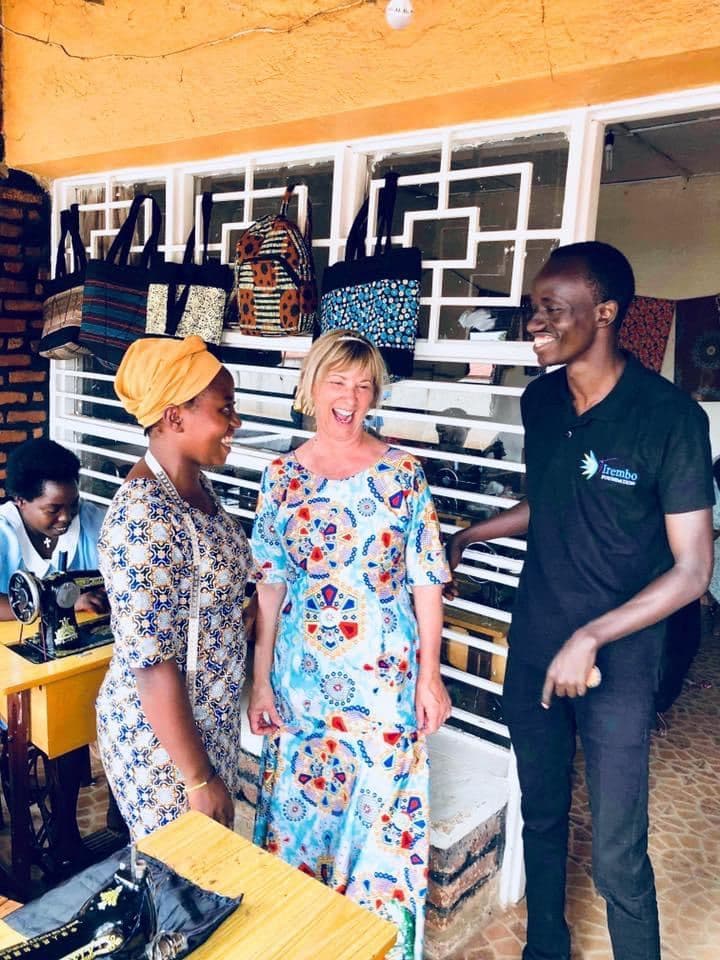 A visitor with a Mama Rwanda trainee and an Irembo team member