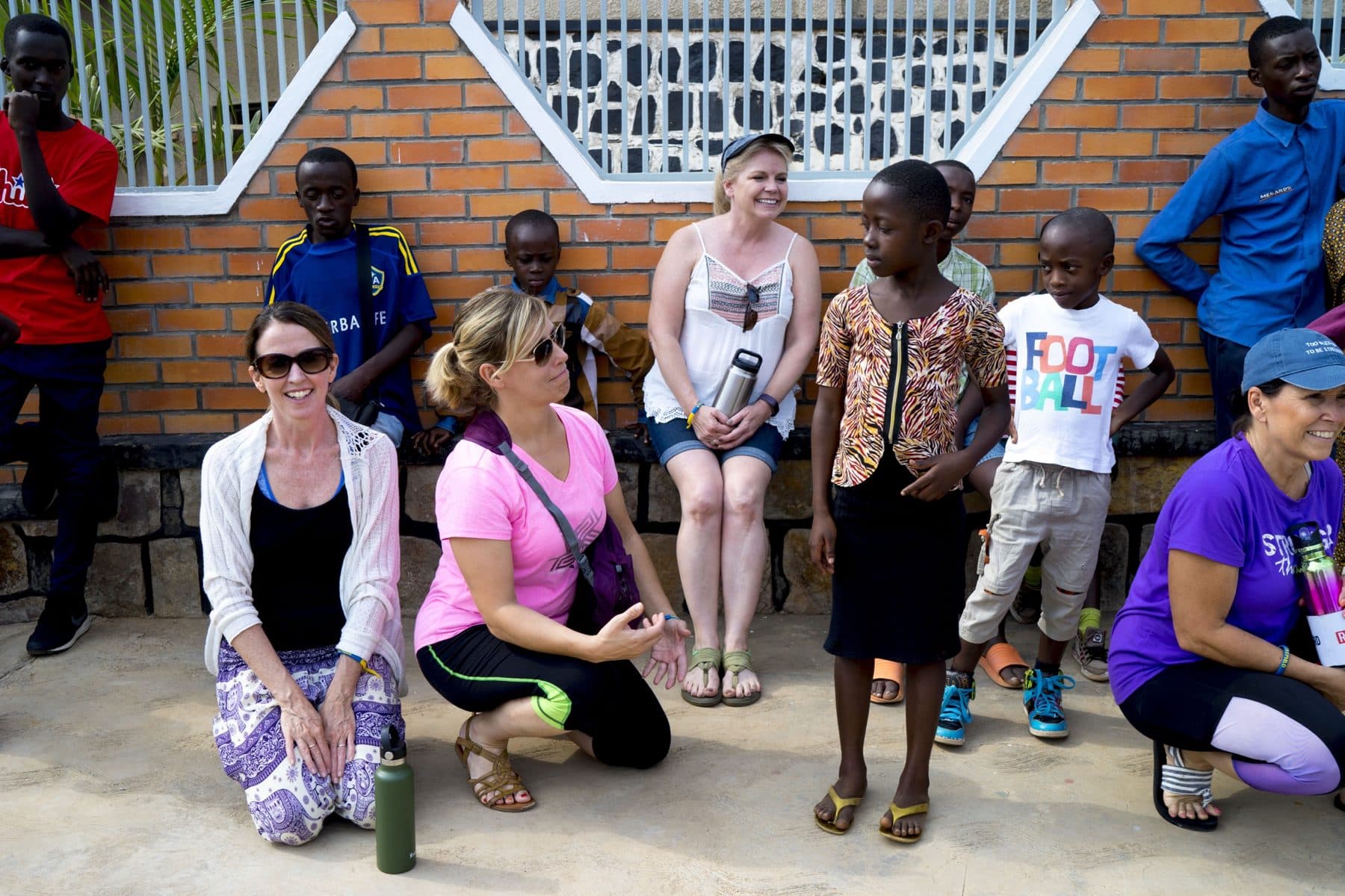 Visitors sitting and talking with Irembo children